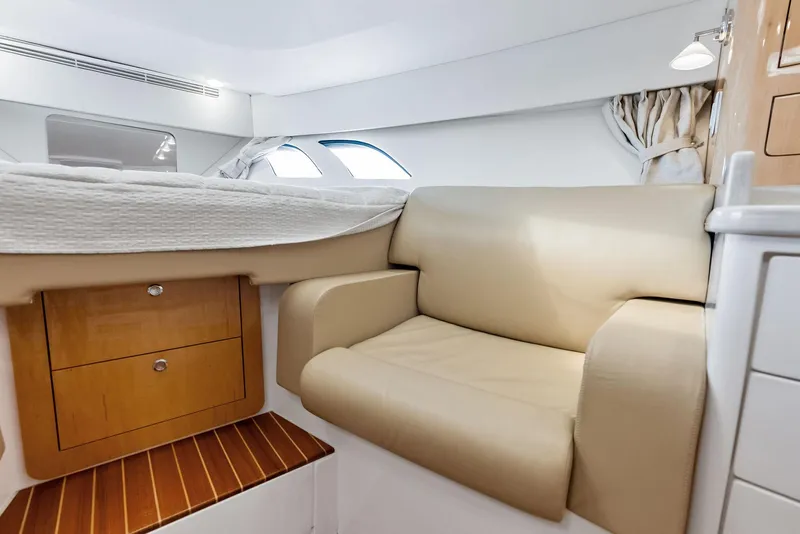 Slide: The Image of 2018 Intrepid 430 Sport Yacht interior with beige seating and wooden drawers. - 41