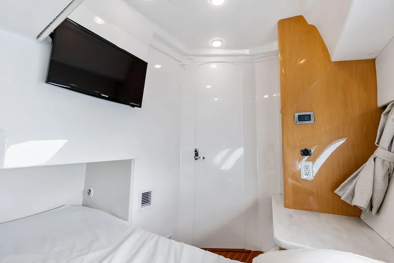 Slide: The Image of 2018 Intrepid 430 Sport Yacht cabin interior with TV and modern amenities. - 46