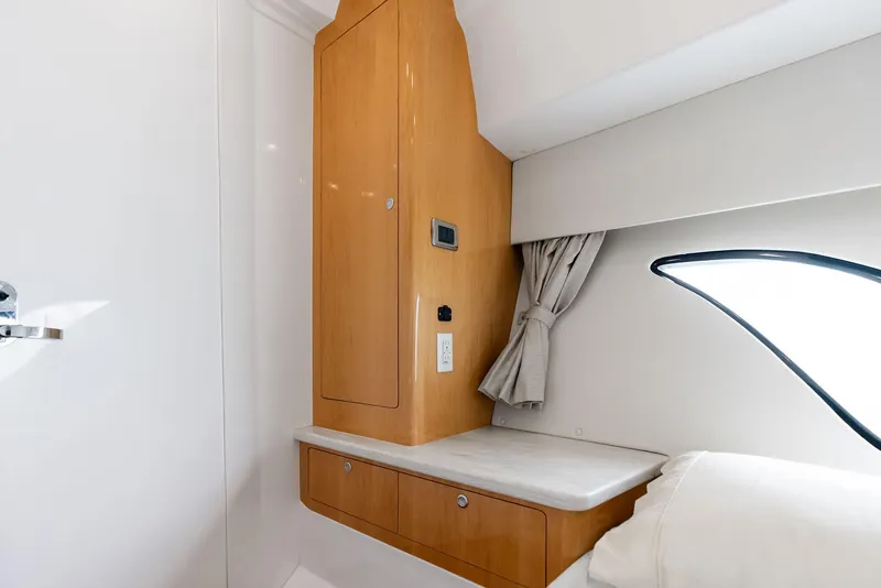 Slide: The Image of 2018 Intrepid 430 Sport Yacht interior with wooden cabinetry and modern design. - 47