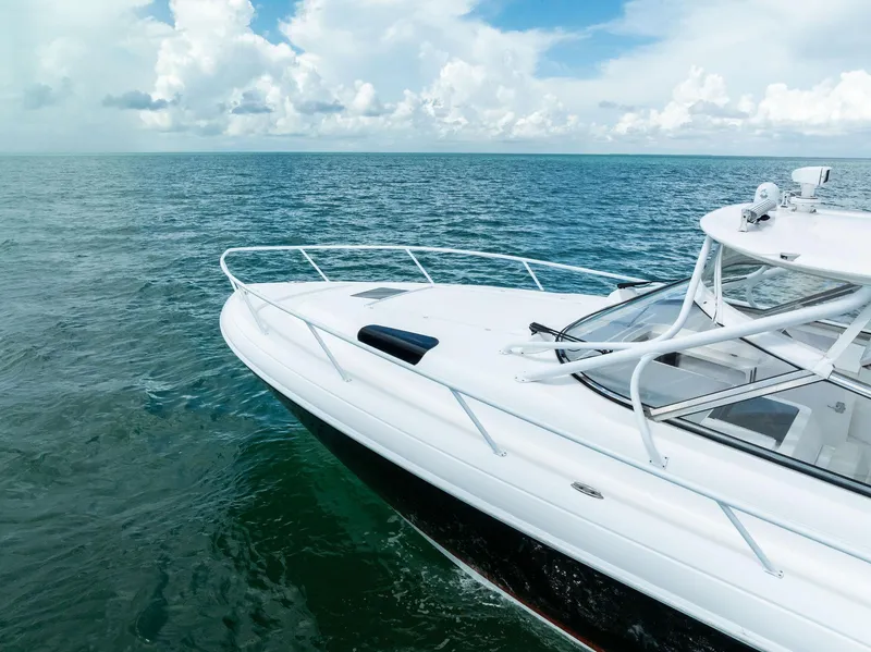 Slide: The Image of 2018 Intrepid 430 Sport Yacht on water, featuring triple outboard engines. - 8