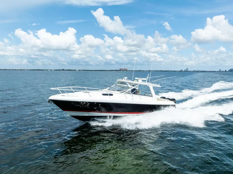 Slide: The Image of 2018 Intrepid 430 Sport Yacht cruising on open sea under blue sky. - 9