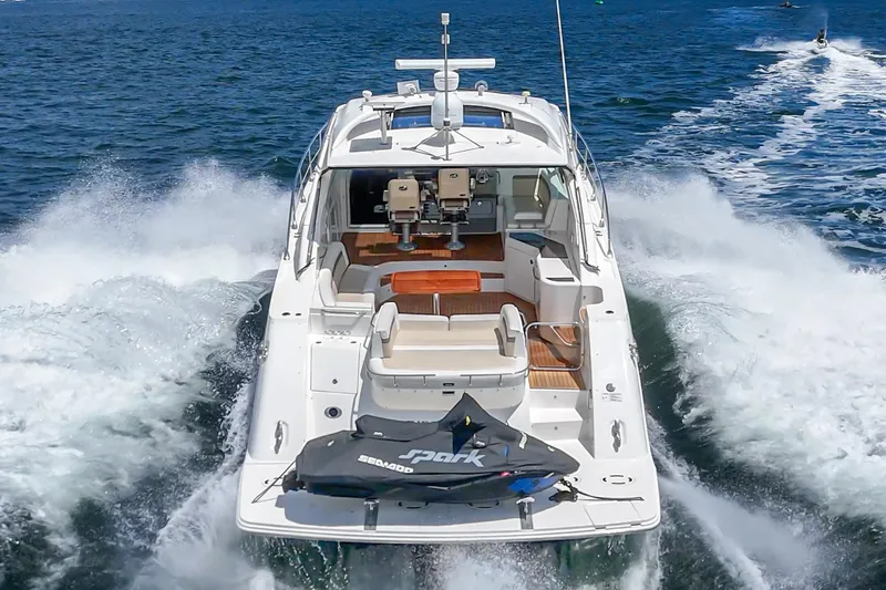 Slide: The Image of Sea Ray 540 Sundancer 2014 cruising on open water with jet ski onboard. - 12