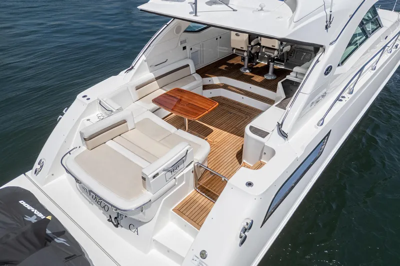 Slide: The Image of 2014 Sea Ray 540 Sundancer yacht with spacious deck and seating area on the water. - 14