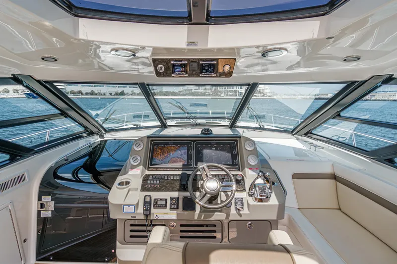 Slide: The Image of 2014 Sea Ray 540 Sundancer helm with modern navigation equipment and panoramic windows. - 17