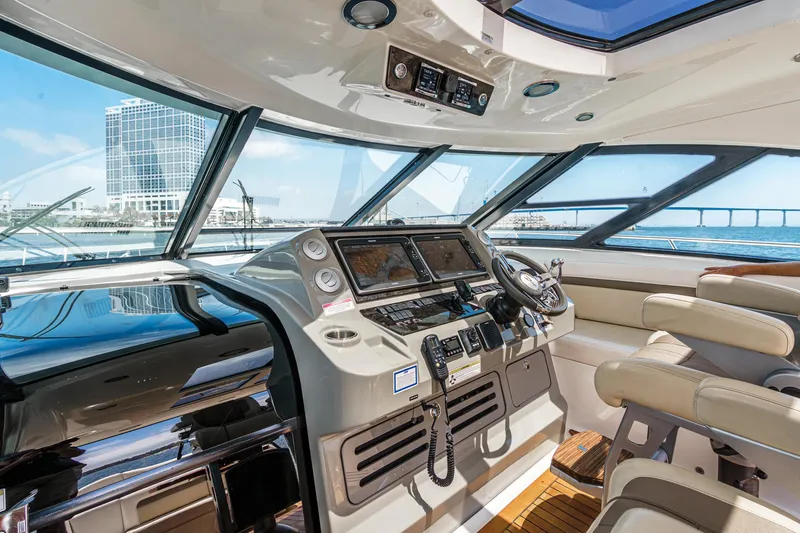 Slide: The Image of 2014 Sea Ray 540 Sundancer helm with modern controls and ocean view. - 19