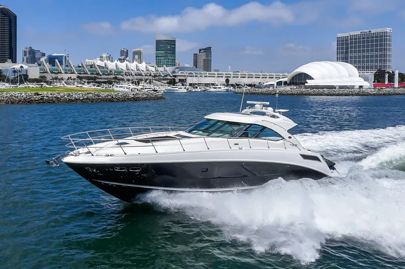 Slide: The Image of 2014 Sea Ray 540 Sundancer yacht cruising near city waterfront. - 2