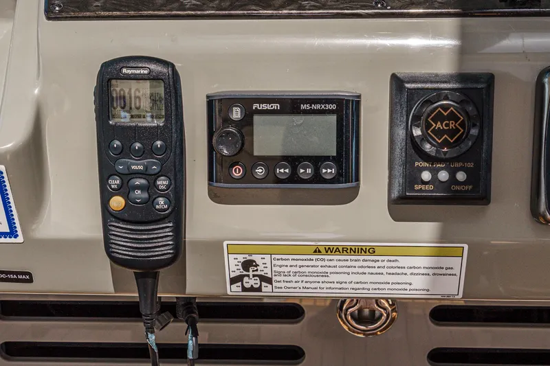 Slide: The Image of Control panel of 2014 Sea Ray 540 Sundancer with Raymarine, Fusion, and ACR devices. - 23