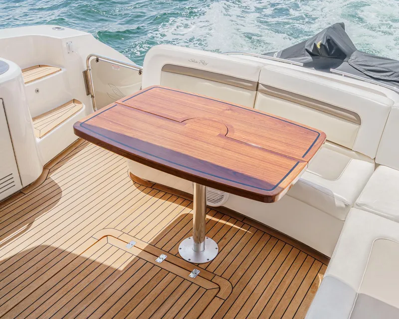 Slide: The Image of Luxury deck of 2014 Sea Ray 540 Sundancer with wooden table and seating. - 29