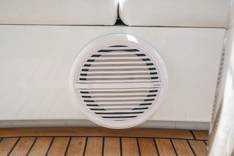 Slide: The Image of Speaker on 2014 Sea Ray 540 Sundancer yacht, featuring teak flooring and white seating. - 30