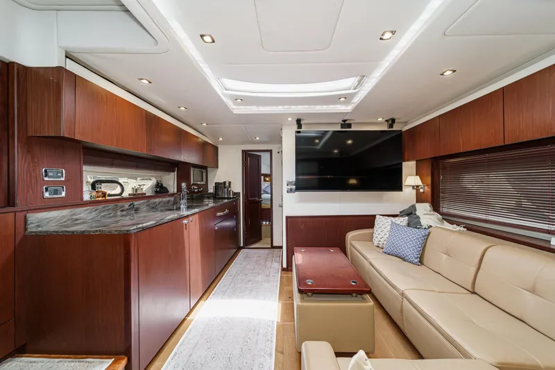 Slide: The Image of Luxurious interior of 2014 Sea Ray 540 Sundancer yacht with modern kitchen and seating area. - 34
