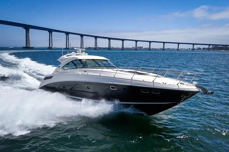 Slide: The Image of 2014 Sea Ray 540 Sundancer yacht cruising near a bridge on a sunny day. - 4