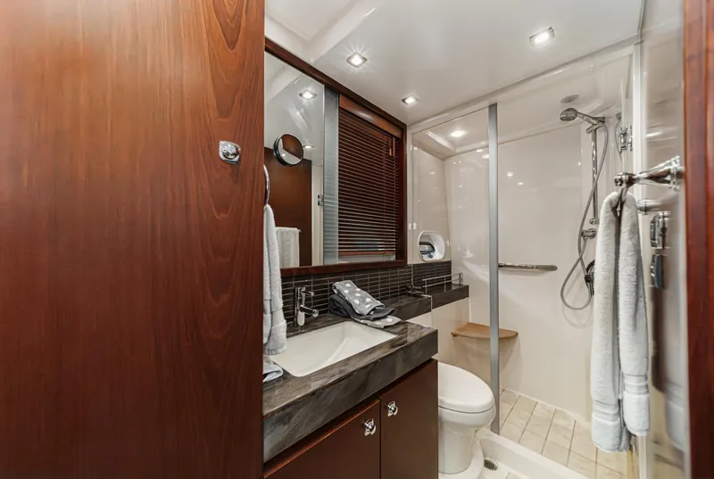 Slide: The Image of Luxurious bathroom in 2014 Sea Ray 540 Sundancer yacht with modern fixtures and wood accents. - 48