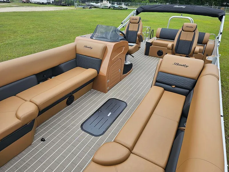 Slide: The Image of 2026 Bentley Pontoons Elite 253 interior with tan and black seating, dual captain chairs, and spacious layout. - 10