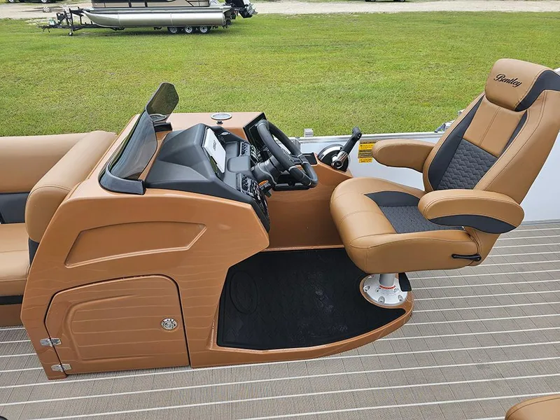 Slide: The Image of 2026 Bentley Pontoons Elite 253 helm with dual captain seats and modern dashboard. - 18