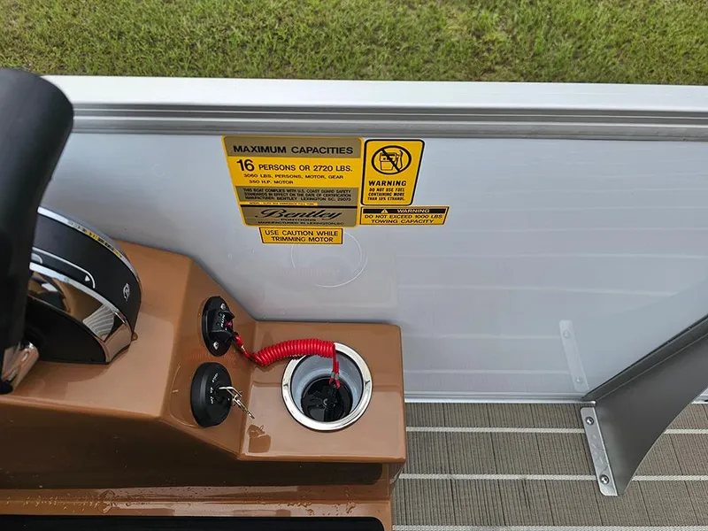 Slide: The Image of Control panel of 2026 Bentley Pontoons Elite 253 with capacity warning label. - 19