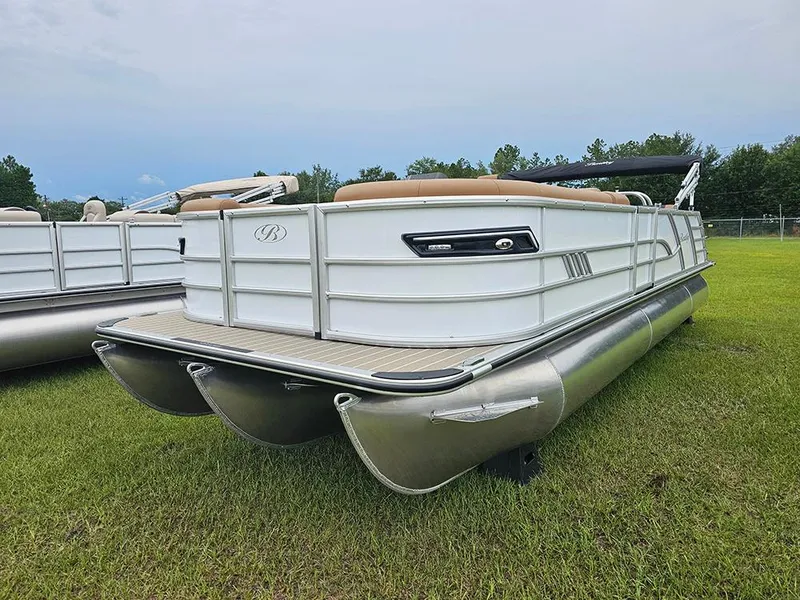 Slide: The Image of 2026 Bentley Pontoons Elite 253 Swingback Dual Captain Full Tritoon on grass, showcasing sleek design. - 2