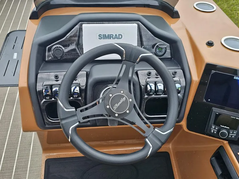 Slide: The Image of Steering console of 2026 Bentley Pontoons Elite 253 Swingback Tritoon with Simrad display. - 21