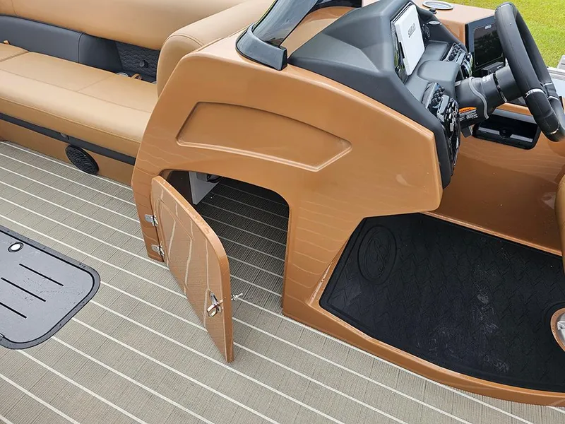 Slide: The Image of 2026 Bentley Pontoons Elite 253 interior with captain's console and open storage compartment. - 22