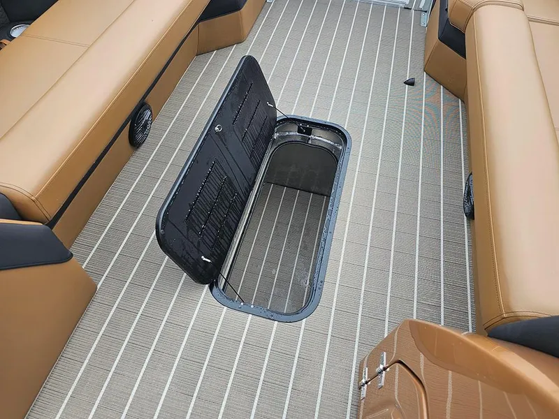 Slide: The Image of 2026 Bentley Pontoons Elite 253 interior with open storage compartment on striped flooring. - 24
