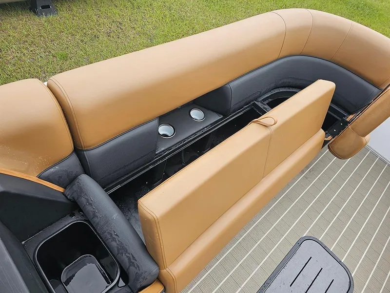 Slide: The Image of 2026 Bentley Pontoons Elite 253 Swingback interior seating with cup holders, tan and black upholstery. - 25