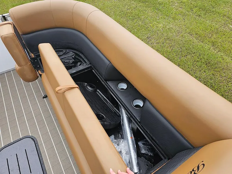 Slide: The Image of 2026 Bentley Pontoons Elite 253 Swingback interior storage compartment with tan seating and cup holders. - 26