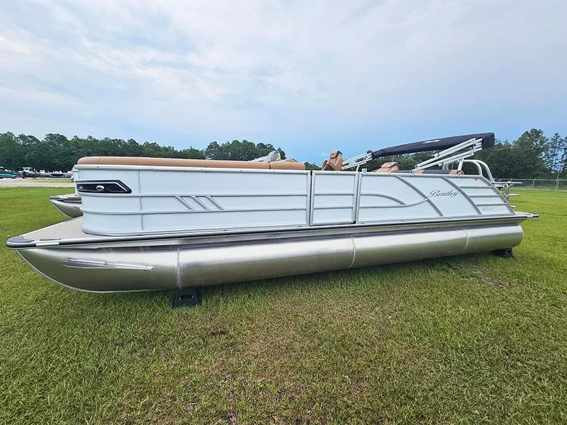 Slide: The Image of 2026 Bentley Pontoons Elite 253 Swingback Tritoon on grassy field. - 3