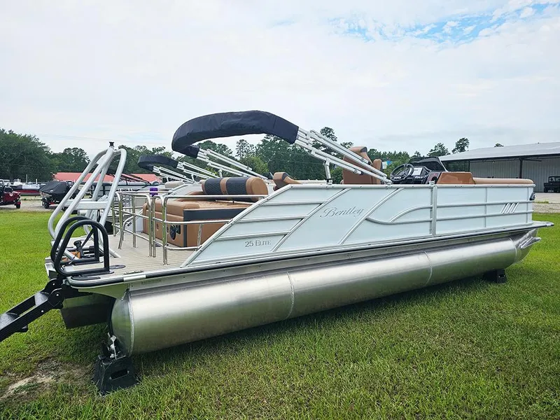 Slide: The Image of 2026 Bentley Pontoons Elite 253 Swingback Dual Captain Full Tritoon on grass, showcasing luxury design. - 6