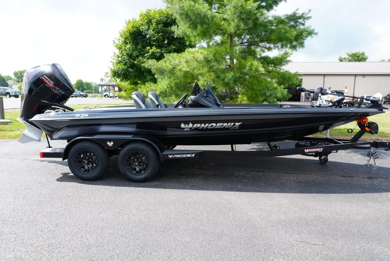 Slide: The Image of 2026 Phoenix 721 ZXL boat on trailer, parked outdoors near trees. - 1