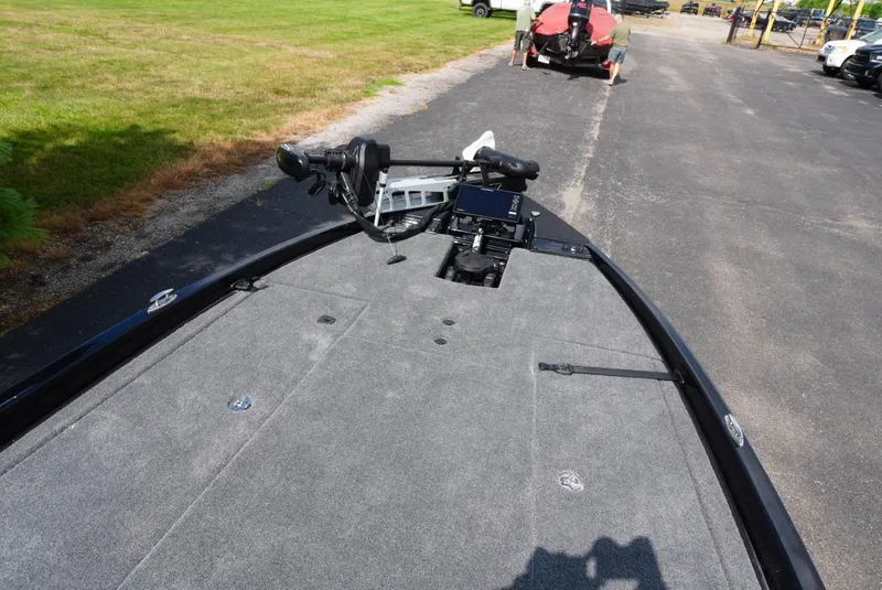 Slide: The Image of 2026 Phoenix 721 ZXL boat deck with trolling motor and control panel on a sunny day. - 13