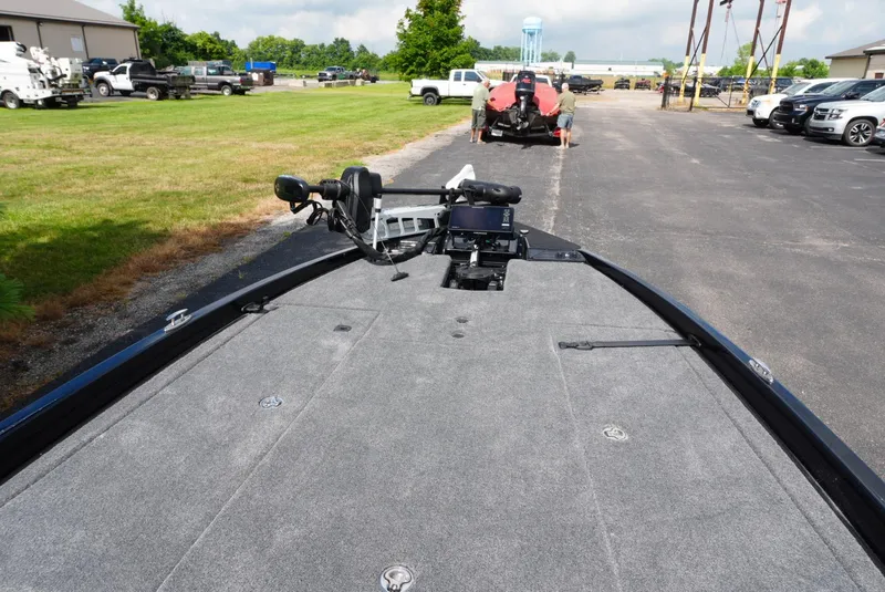 Slide: The Image of 2026 Phoenix 721 ZXL boat with spacious deck, parked outdoors near vehicles. - 14