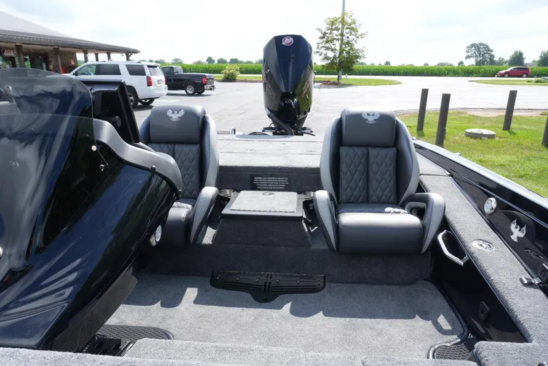 Slide: The Image of 2026 Phoenix 721 ZXL boat interior with dual seats and outboard motor in parking area. - 15