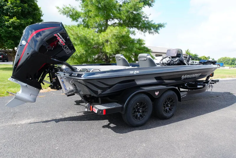 Slide: The Image of 2026 Phoenix 721 ZXL boat with powerful outboard motor, parked on a sunny day. - 2