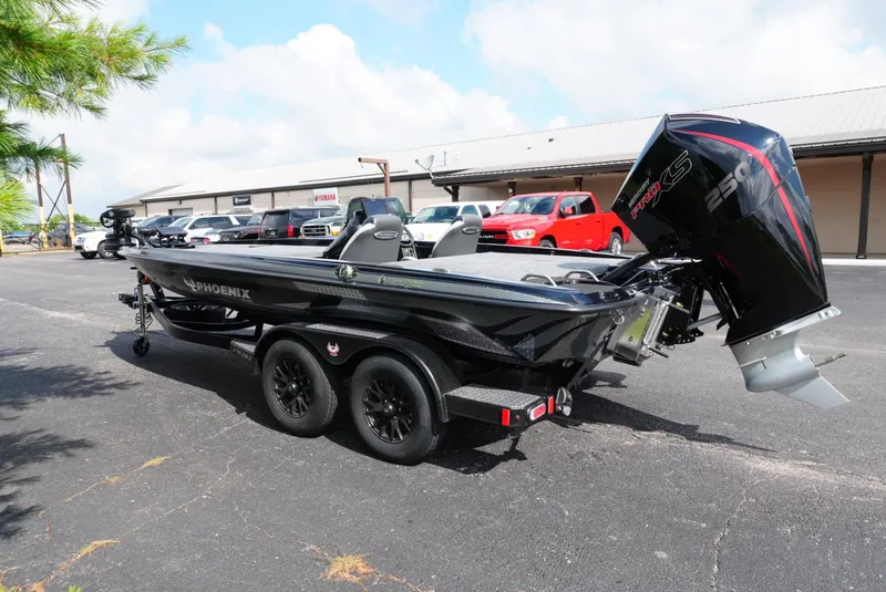 Slide: The Image of 2026 Phoenix 721 ZXL boat with powerful engine, parked on a trailer in a lot. - 3