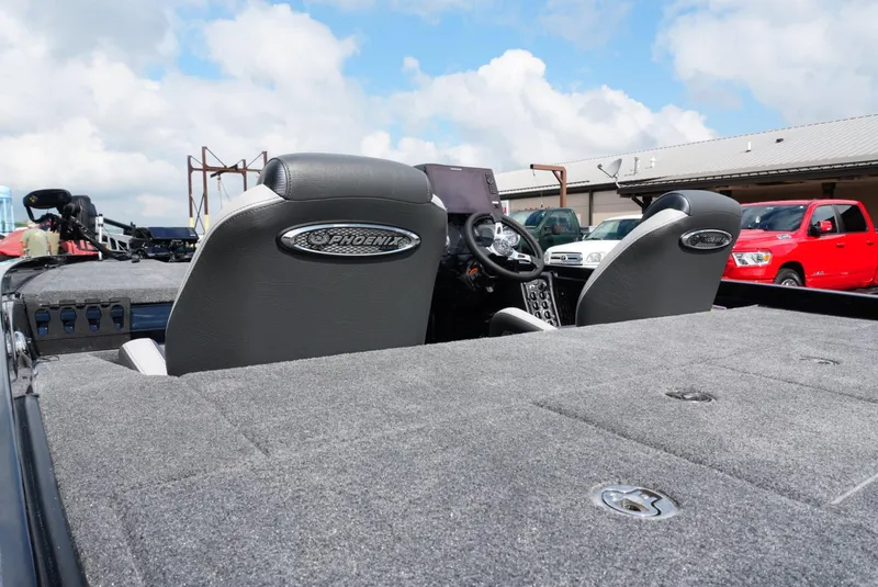 Slide: The Image of 2026 Phoenix 721 ZXL boat interior with dual seats and steering wheel, parked outdoors. - 6