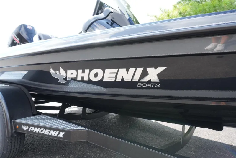 Slide: The Image of 2026 Phoenix 721 ZXL boat with logo on trailer, sleek black design. - 9