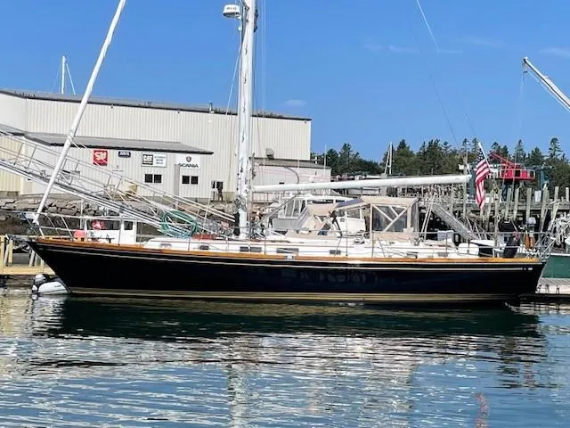 Slide: The Image of Bristol 47.7 Cutter/Sloop, 1990 model, docked at a marina with clear blue skies. - 0