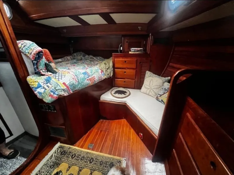 Slide: The Image of Cozy cabin interior of 1990 Bristol 47.7 Cutter/Sloop with colorful bedding and wooden furnishings. - 13