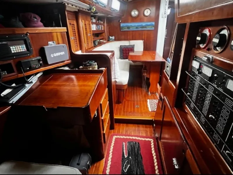 Slide: The Image of Interior of 1990 Bristol 47.7 Cutter/Sloop with wooden furnishings and navigation equipment. - 15