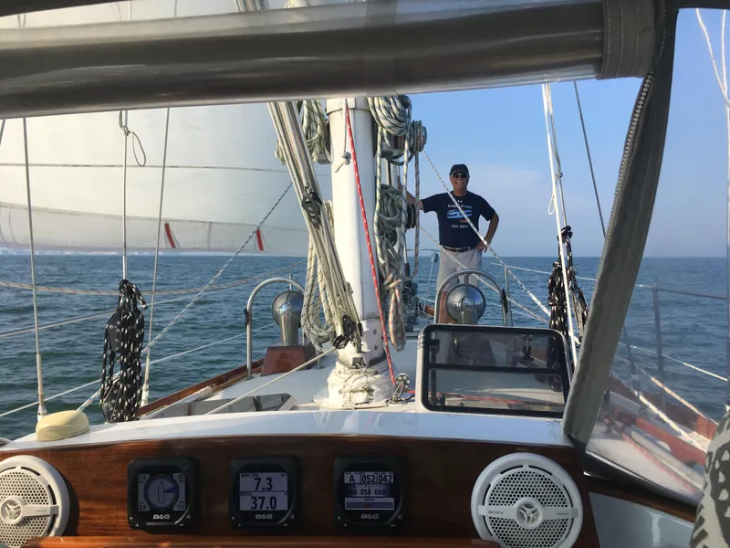 Slide: The Image of Sailing on a 1990 Bristol 47.7 Cutter/Sloop with a person on deck, clear skies. - 19