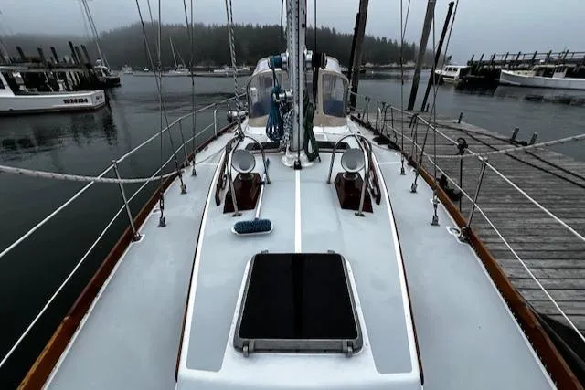 Slide: The Image of Sailboat deck view of 1990 Bristol 47.7 Cutter/Sloop docked in a misty marina. - 30