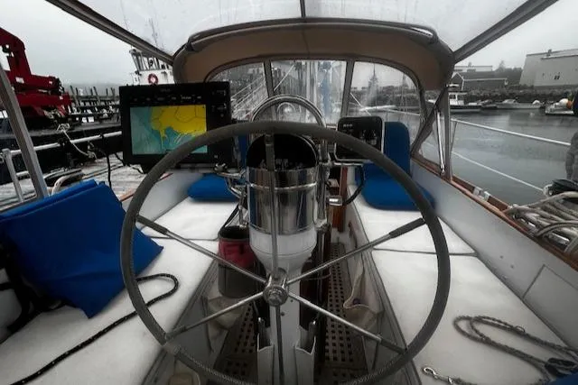 Slide: The Image of Cockpit of a 1990 Bristol 47.7 Cutter/Sloop with navigation equipment and steering wheel. - 35