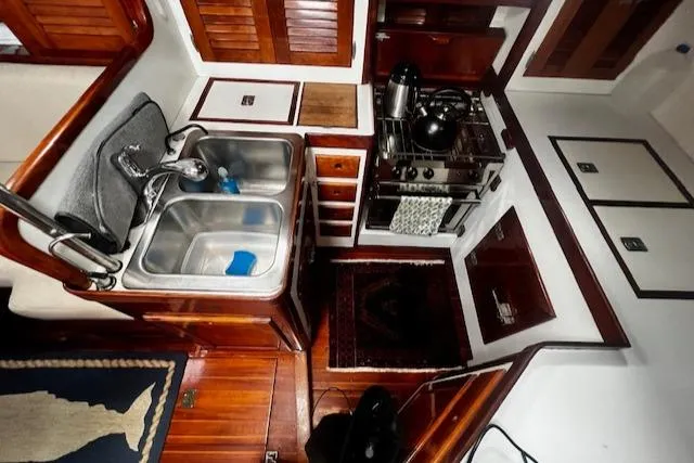 Slide: The Image of Interior of 1990 Bristol 47.7 Cutter/Sloop showing compact kitchen with sink and stove. - 8