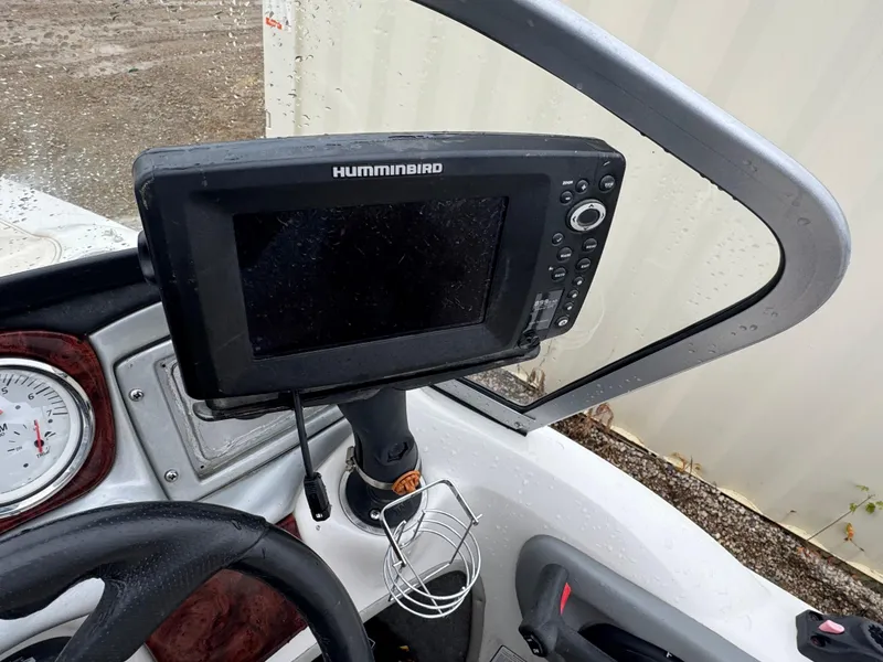 Slide: The Image of 2011 Nitro 290 Sport boat interior with storage compartment and red-white seating. - 10