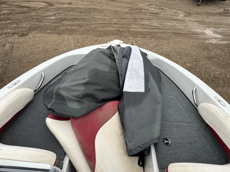 Slide: The Image of Interior of 2011 Nitro 290 Sport boat with red and white seating. - 11