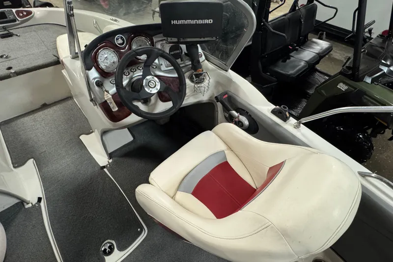 Slide: The Image of 2011 Nitro 290 Sport boat cockpit with steering wheel and Humminbird display. - 12