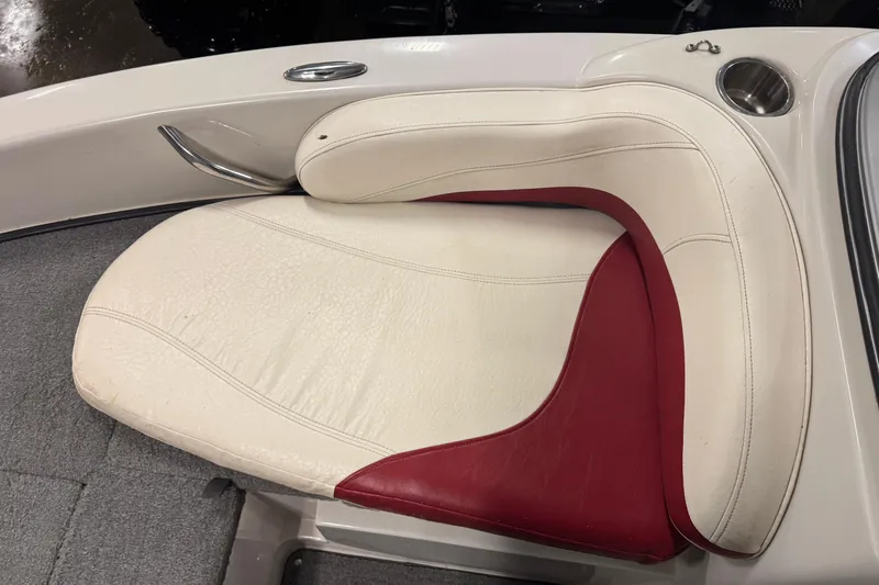 Slide: The Image of White and red seating on 2011 Nitro 290 Sport boat, featuring cup holder and handle. - 16