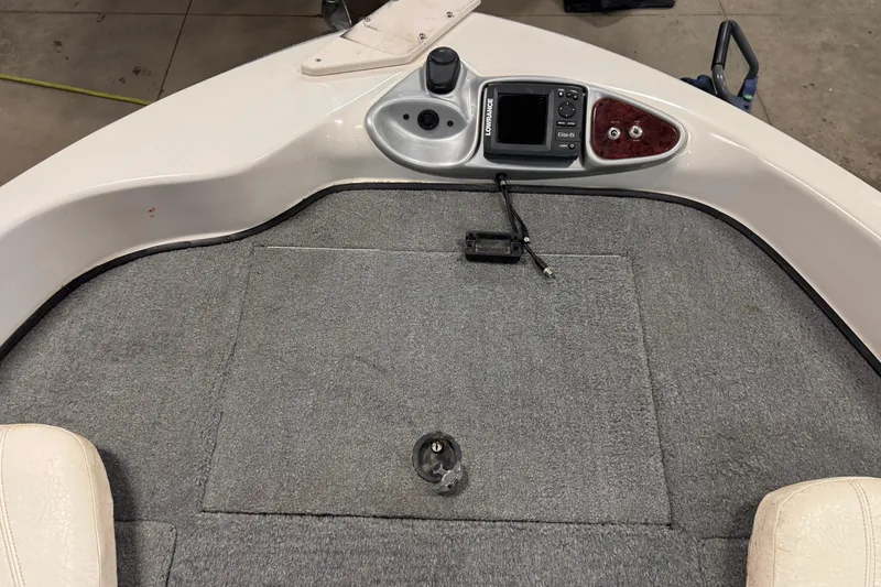 Slide: The Image of 2011 Nitro 290 Sport boat deck with control panel and carpeted surface. - 17