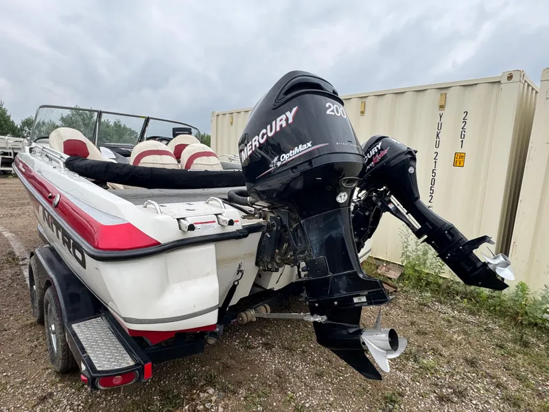 Slide: The Image of 2011 Nitro 290 Sport boat with Mercury engine in a garage setting. - 4