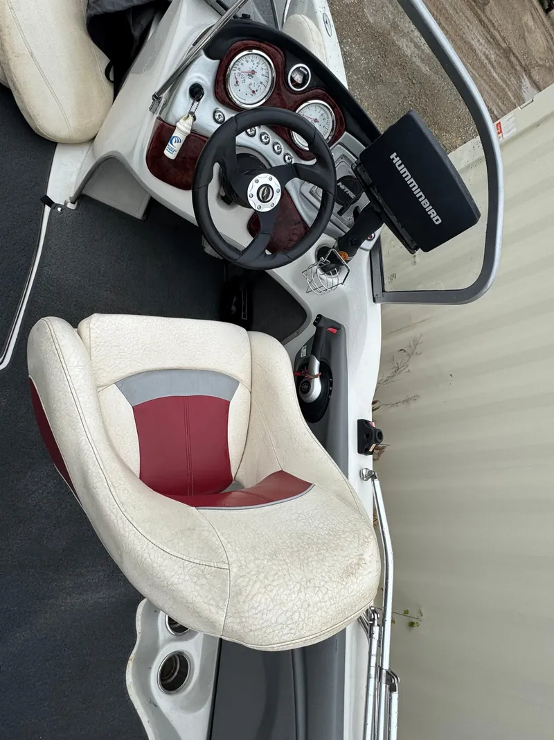 Slide: The Image of 2011 Nitro 290 Sport boat with Mercury engine in a garage setting. - 5