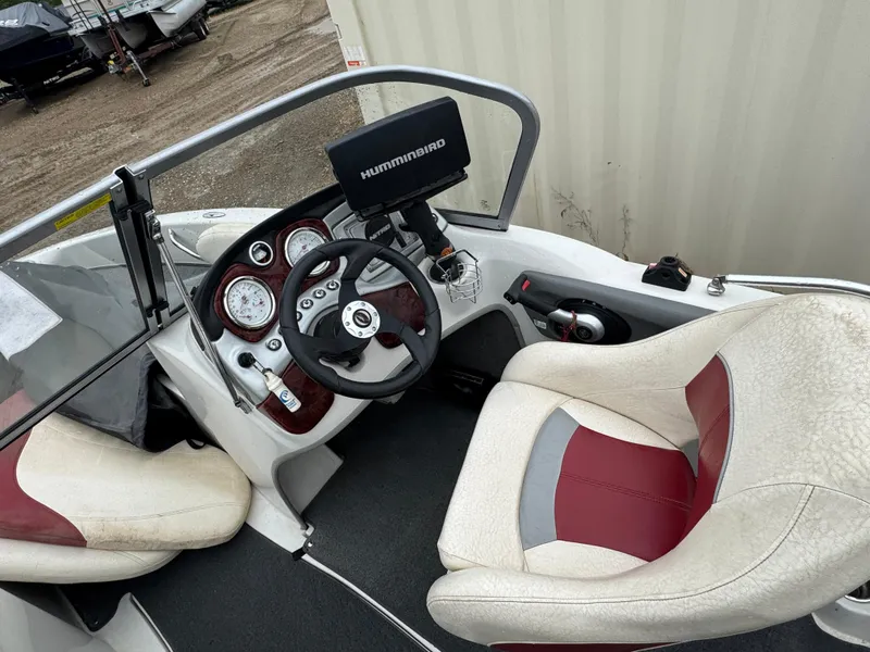Slide: The Image of 2011 Nitro 290 Sport boat in a garage, featuring a red and white design. - 6